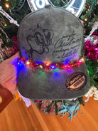 Green Suede “Maybe Christmas” Trucker Hat with Light-Up Garland Chain